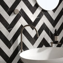 Classica black and white marble effect tiles laid in herringbone pattern in bathroom