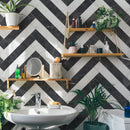 Classica black and white marble effect tiles laid in herringbone pattern on bathroom wall