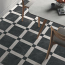 Classica black and white marble effect tiles laid in a Cassettone pattern underneath a dining table.