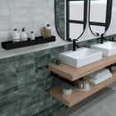 Bathroom with a white and green tiled walls, two basins and wooden shelves.