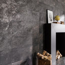Dark stone effect wall tiles with a fireplace and decorative items