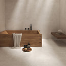 Bathroom with beige wall and floor tiles and a wooden bath