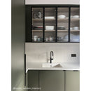 Kitchen with green cupboards and off white fluted wall tiles