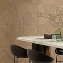 Dining area with a marble table and chairs and geometric wood effect wall tiles.