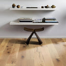 White floating shelves with books and decorative items on a wooden floor.