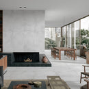 Modern living room with a fireplace, bookshelf, large windows and light grey floor tiles.