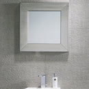 Silver-framed mirror and grey textured wall tiles.