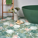 Bathroom with green bathtub and floral-patterned tiles