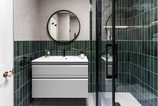 Bathroom with green metro tiles, beige terrazzo tiles matt black fixtures.