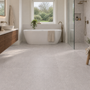 Light grey stone effect floor tiles in a modern, bright bathroom with a freestanding bathtub, glass shower enclosure, wooden vanity, and natural window view.
