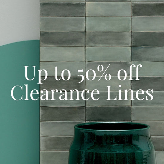 A promotional graphic with the text 'Up to 50% off Clearance Lines' over a close-up of stacked rectangular metro tiles in muted grey green tones.