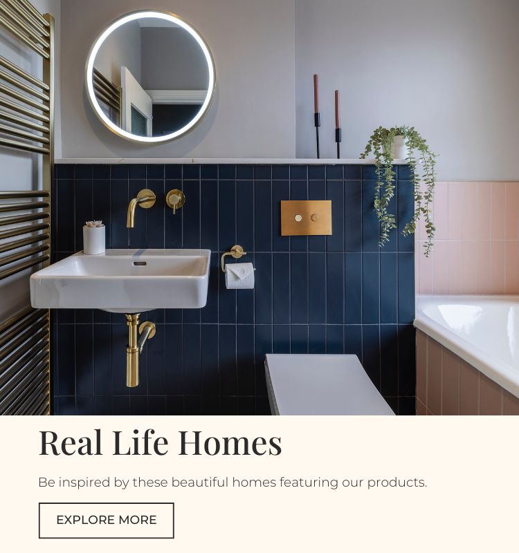 Bathroom with brushed brass fixtures and dark blue and pink metro tiles stacked vertically on the wall.