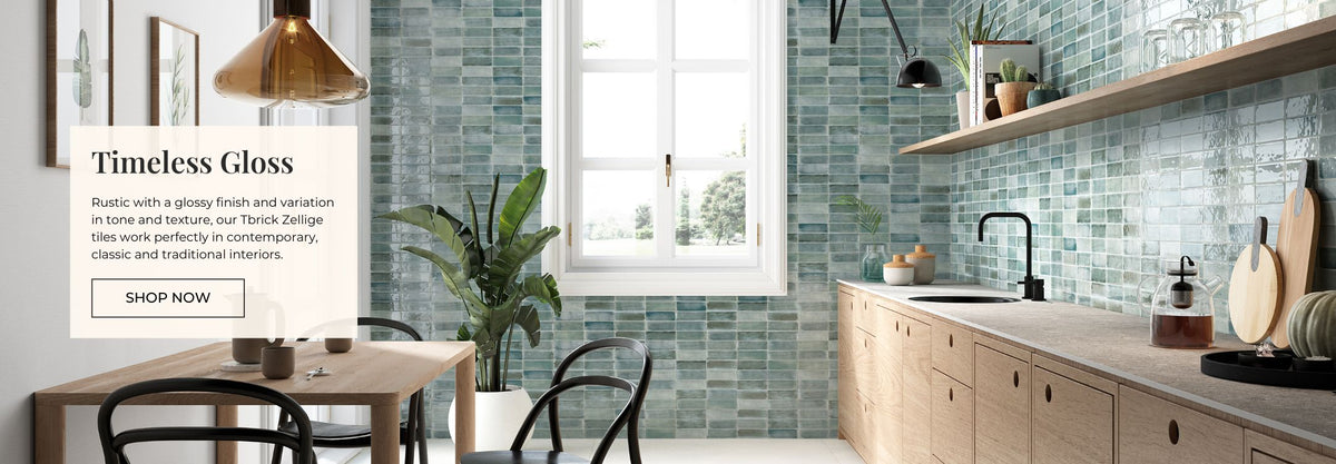 Modern kitchen with light wood cabinets, green tiled backsplash, and a dining table.