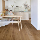 Pale scandi style kitchen with honey toned engineered wood flooring.