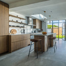 Kitchen with wooden cupboards and large grey floor tiles