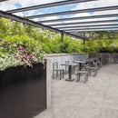 Outdoor patio area with tables, chairs with grey paving.