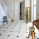 Hallway with white marble effect floor tiles.