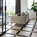 Classica marble effect tiles laid in a Cassettone pattern on a living room floor.