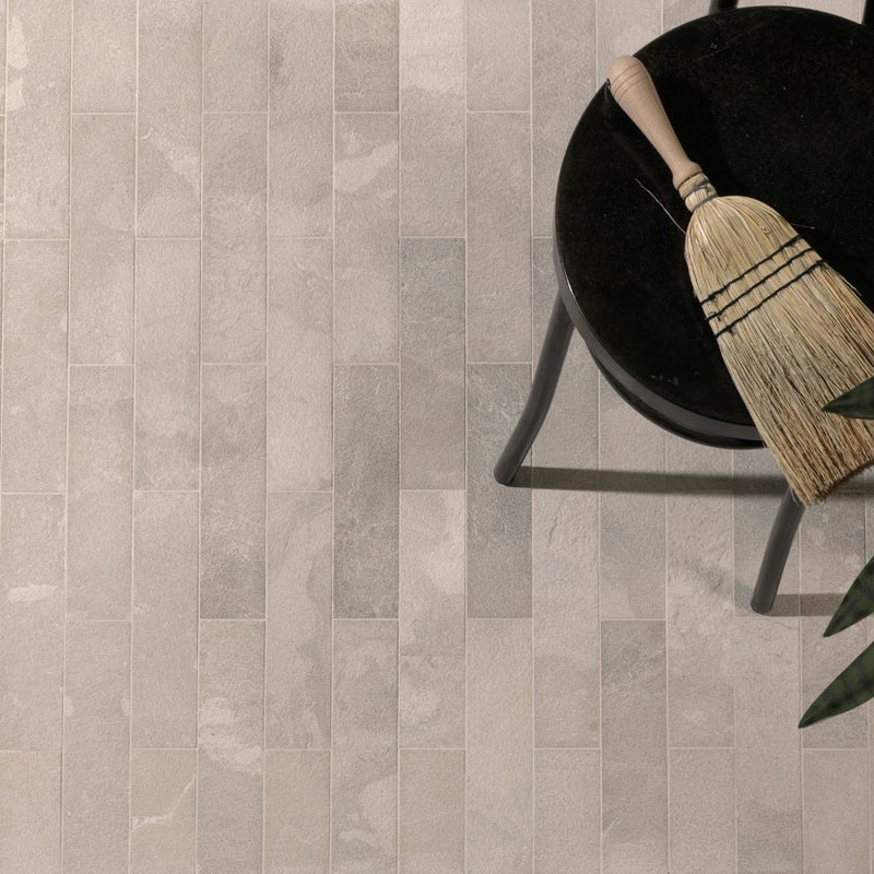 Limestone parquet floor with a broom and chair