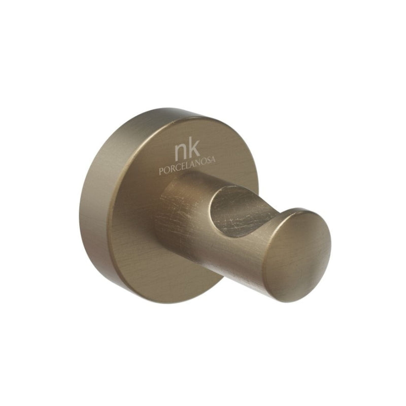 Brass-colored wall hook with 'nk' branding on a white background