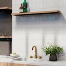 Modern kitchen with white kit kat mosaic tiles on the wall and a gold tap.