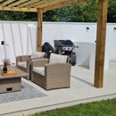 Outdoor patio with wicker chairs, coffee table, and barbecue on large beige paving slabs.