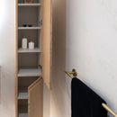 Bathroom with wooden cabinet, candles on shelves, and a black towel on a gold rail.