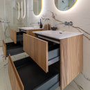 Wooden bathroom vanity unit with open drawers with marble marble effect tiles.