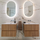 Bathroom with two wooden vanities, mirrors, and marble effect tiled walls