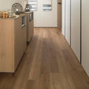 Hallway with wood effect luxury vinyl flooring and cabinets on either side.