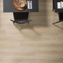 Dining area with tables and chairs on a wood effect luxury vinyl floor.