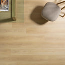 Wooden coffee table with a glass top on a wood effect luxury vinyl floor and a grey fabric stool.