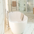 Modern bathroom with a freestanding bathtub and floorstanding chrome bath mixer and marble effect tiles.