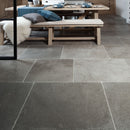 Natural stone floor and wooden bench with cushions in the background