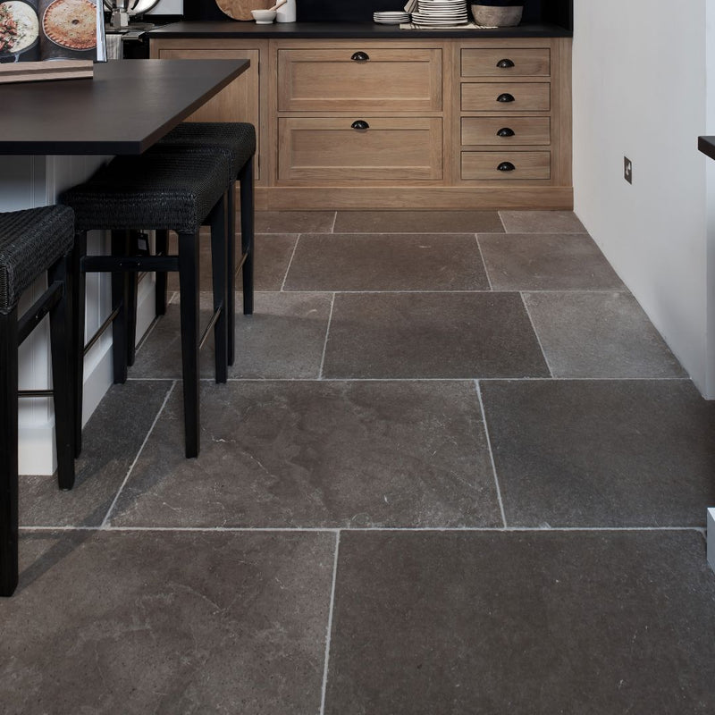 Kitchen with natural stone floor and wooden cabinets