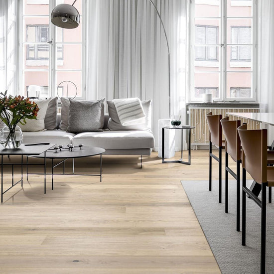 Bright living room with a sofa, coffee table and pale wooden flooring