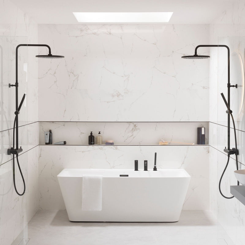 Modern bathroom with a freestanding bathtub, marble effect tiles and black fixtures.
