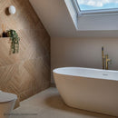 Bathroom with freestanding bath, good tap and textured wood effect tiled wall.