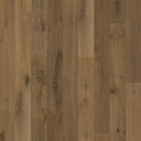 Close-up of a wooden floor with a warm brown color and visible grain pattern.