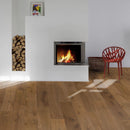 Modern living room with a fireplace, red chair, and wooden floor.