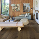 Boho style living area with sofas, wooden wall panelling and dark brown engineered oak flooring,