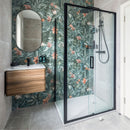Modern bathroom with shower enclosure, floral-patterned tiles, and wooden vanity.
