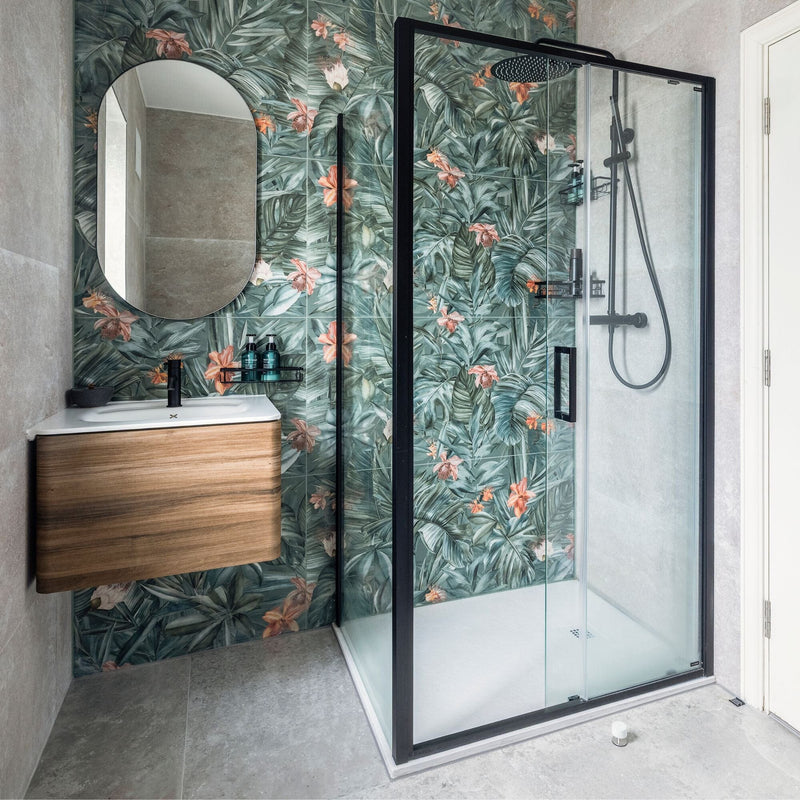 Modern bathroom with shower enclosure, floral-patterned tiles, and wooden vanity.