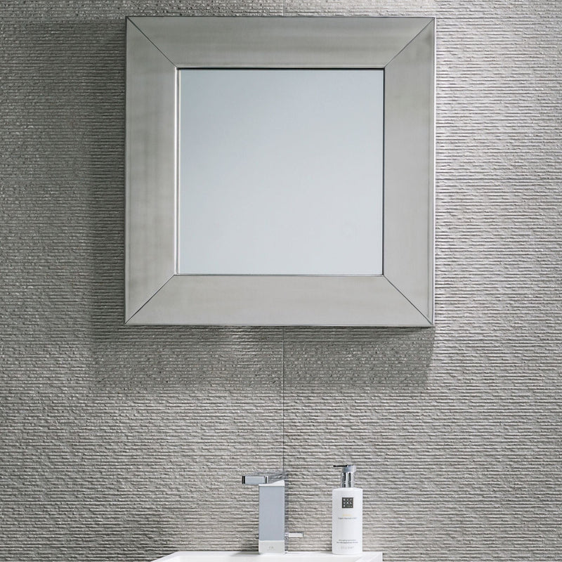 Silver-framed mirror and grey textured wall tiles.