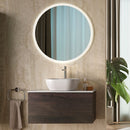 Wooden bathroom vanity with round mirror and plant