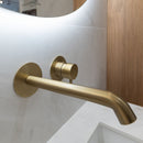 Brushed brass wall mounted tap.
