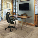 Wooden desk with black office chair on a wooden floor