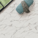 Teal fabric bench on a marble effect tiled floor.