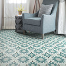 Patterned tile floor with a gray armchair and decorative elements.