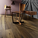 A room showcasing dark oiled oak flooring with a single wooden chair and a small wooden table placed on the floor.